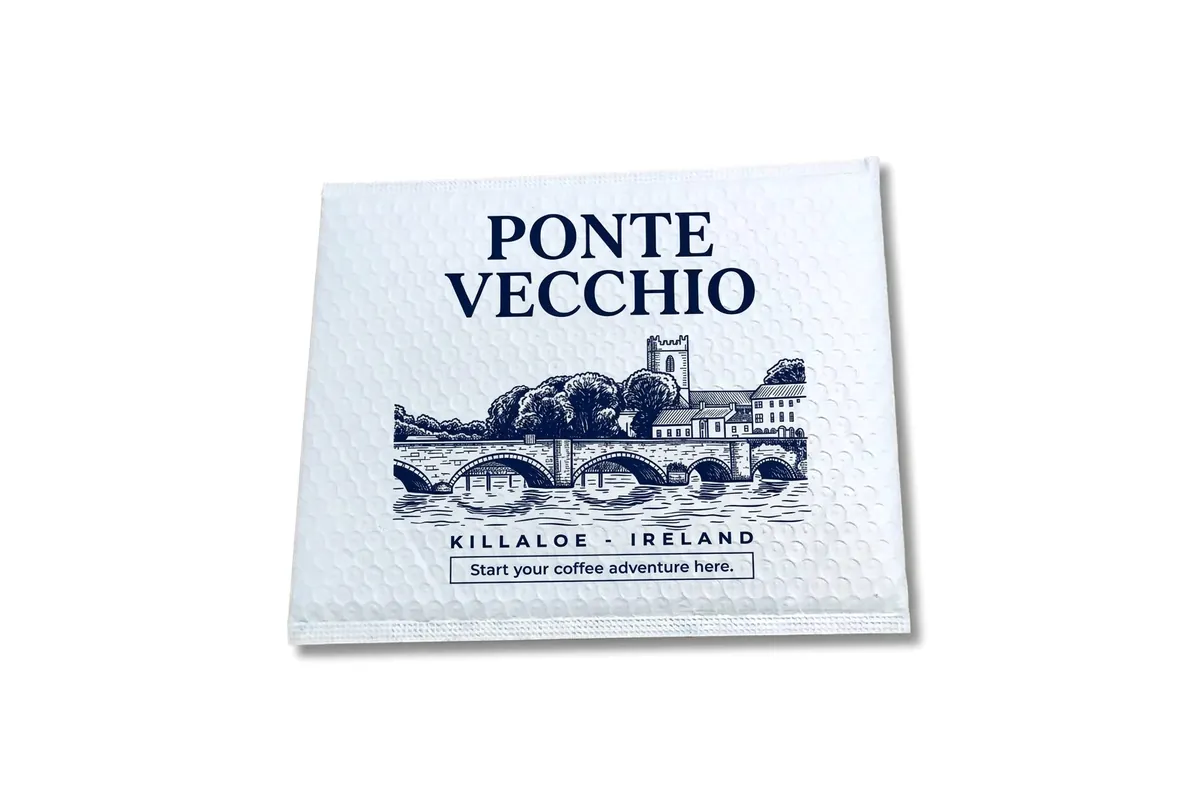 White bubble poly mailer custom printed in navy with a coffee brand's bridge illustration