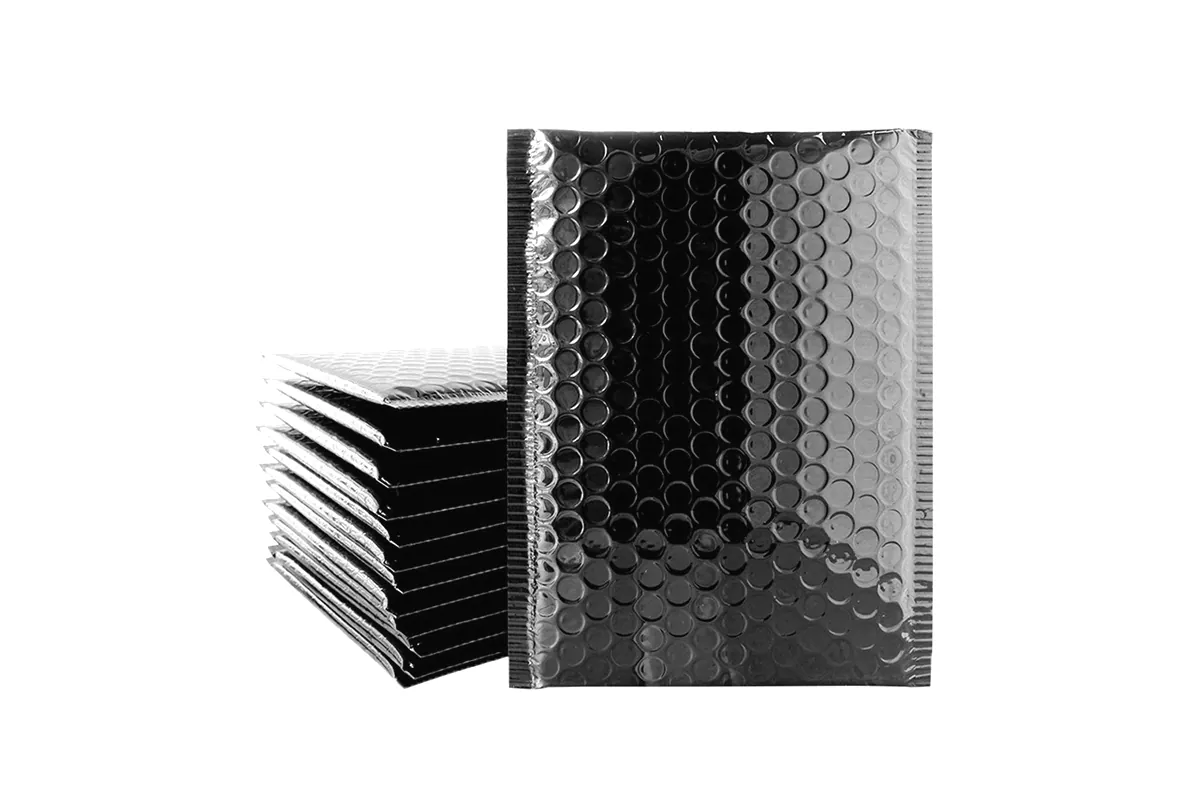 Stack of black metallic bubble mailers beside one standing upright