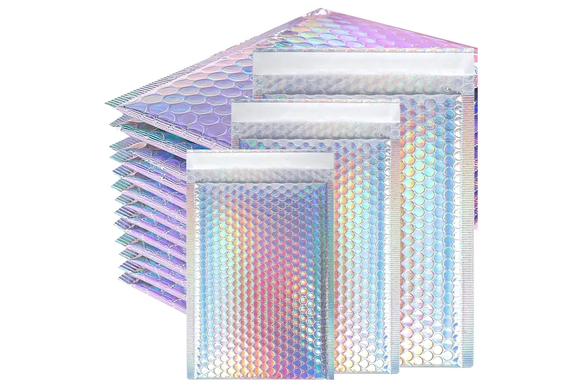 Holographic pearlescent bubble mailers in three sizes in front of a stack