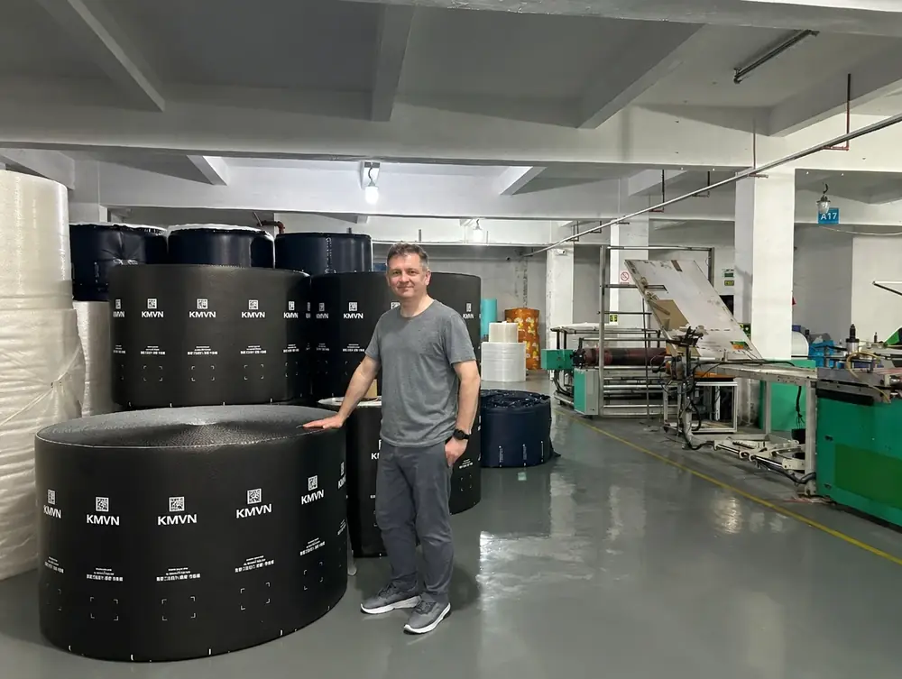 Noel beside rolls of bubble film in our film plant